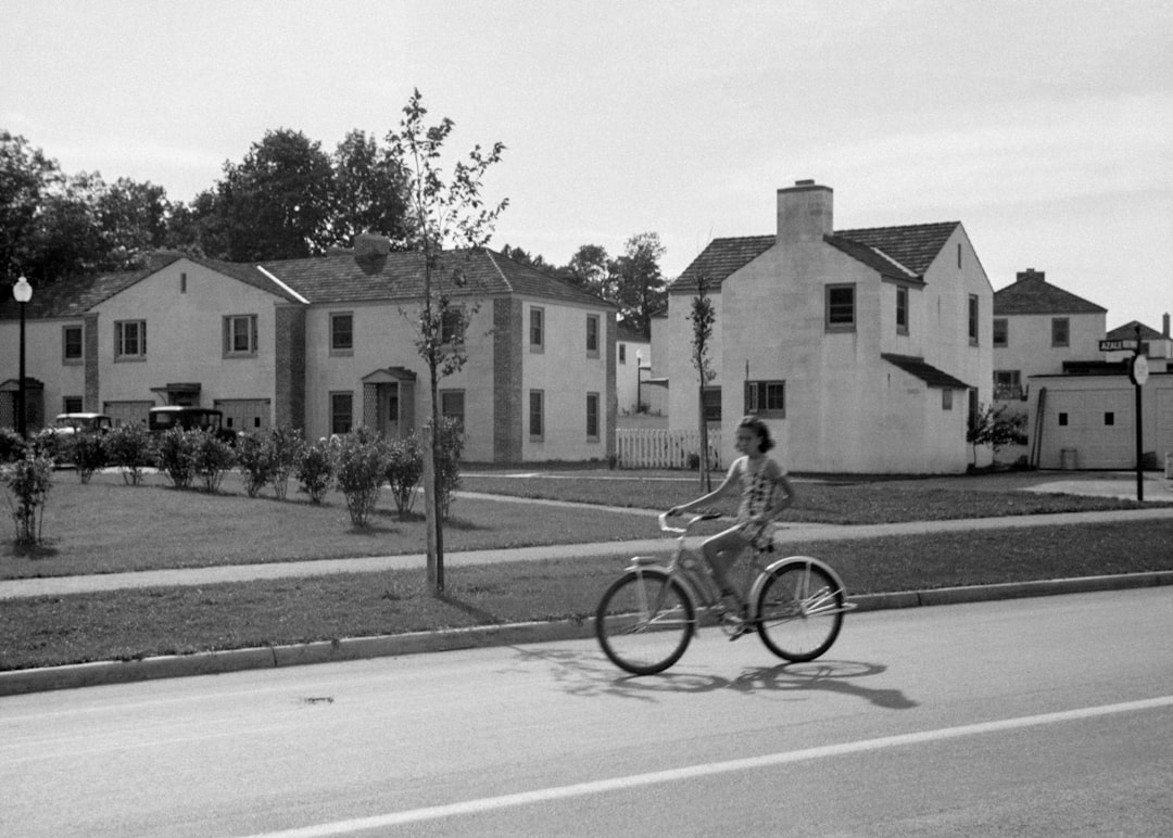 Two kids riding bicycles on suburban street - Unsplash photo by Thomas Park