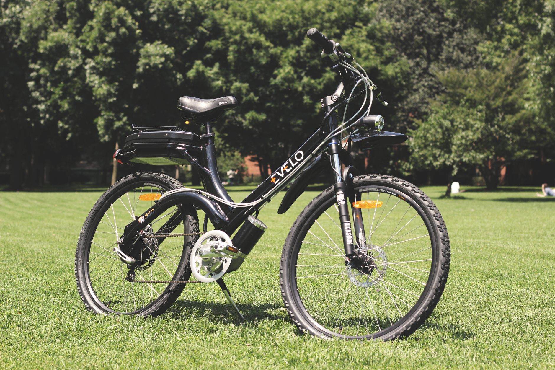 Person cleaning eBike chain with degreaser in home garage workshop