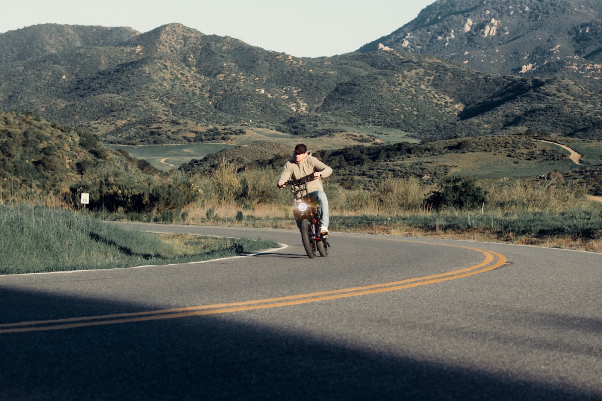 eBike rider climbing steep road during golden hour
